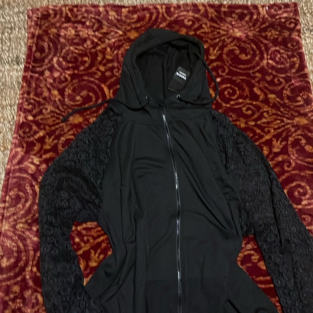 Torrid women’s black casual jacket with lace sleeves.